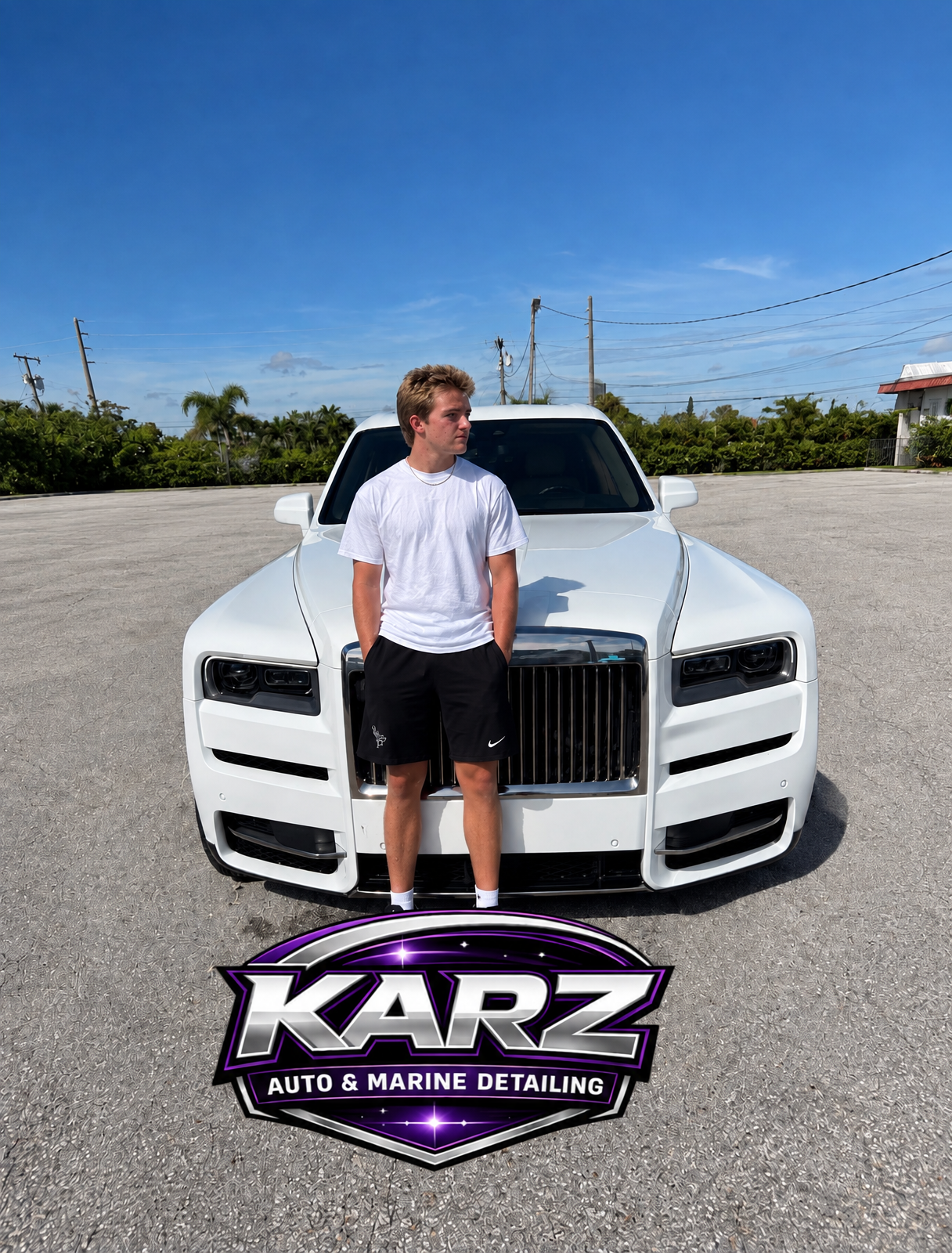 Dylan Karz, owner of KARZ Auto & Marine Detailing, standing in front of a white Rolls-Royce